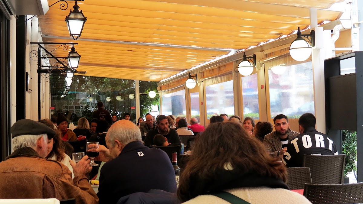 Busy restaurant dining room with tables of guests