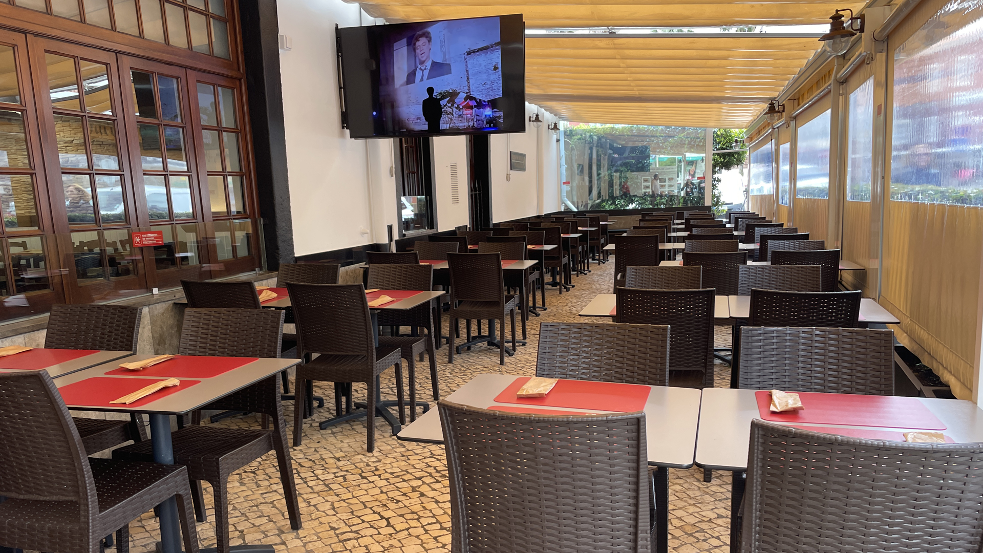 Covered patio dining area with wicker chairs